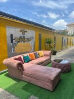 Neatly Used L Shape Peach Sofa With Center Piece And Pillows(Needs Washing) - Image 4