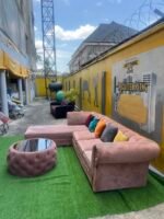 Neatly Used L Shape Peach Sofa With Center Piece And Pillows(Needs Washing) - Image 5