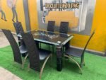 Neatly Used 6 Seater Glass Top Black Dinning Set ( the iron part of the chairs are rusted) - Image 2