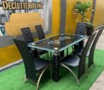 Neatly Used 6 Seater Glass Top Black Dinning Set ( the iron part of the chairs are rusted)