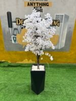Relatively New White & Green Artificial Flower With Black Plastic Vase - Image 3